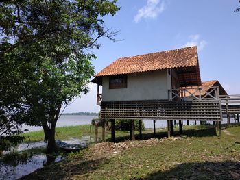 House amidst trees and buildings against sky