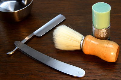 Close-up of shaving equipment on table