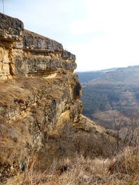 Rock formations on landscape against sky