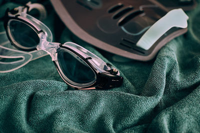 Close-up of swimming goggles on fabric