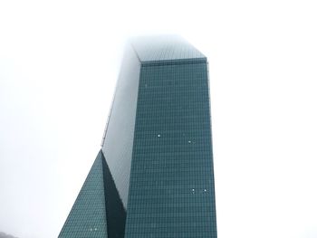 Low angle view of modern buildings against clear sky