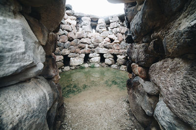 Stone wall by rock formation