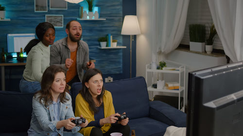 Male and female friends playing video game