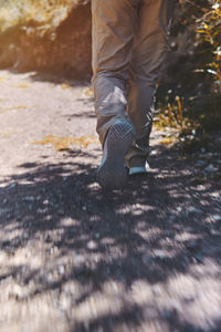 Young tourist walks on a path to the mountain. adventure travel, hiking concept.