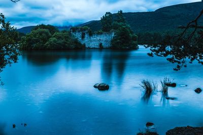 Mystic view of lake against sky with castle