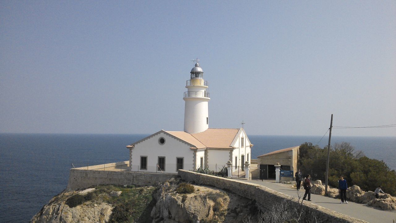 lighthouse, sea, guidance, architecture, built structure, building exterior, water, horizon over water, clear sky, direction, protection, copy space, safety, security, tower, blue, sky, tranquility, day, nature