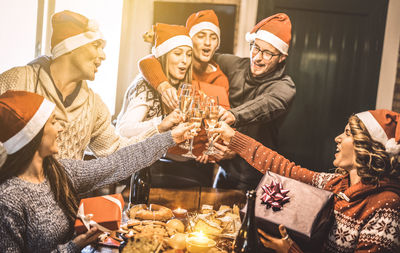 People toasting drinks in glasses