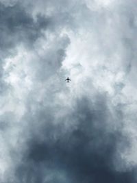 Low angle view of airplane flying in sky