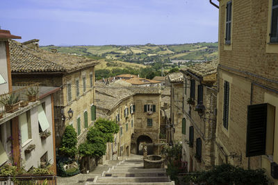 Street amidst buildings in town against sky