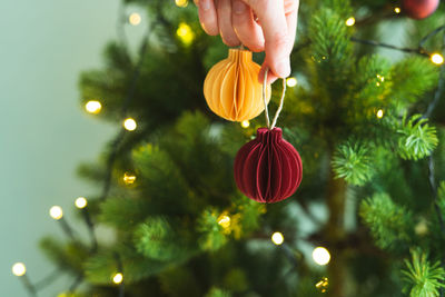 Midsection of person holding christmas tree