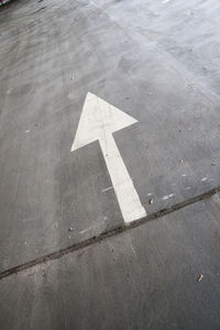 High angle view of arrow sign on road