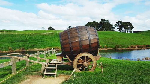 Horse cart on field against sky