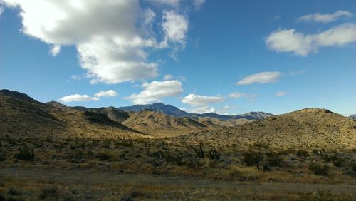 Scenic view of mountains against cloudy sky