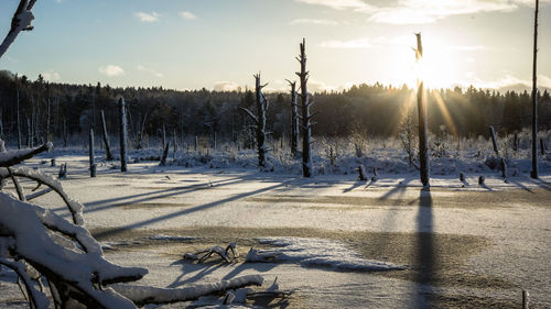 Scenic view of snow field against sky during sunset