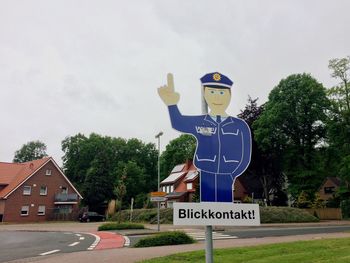 Road sign against sky