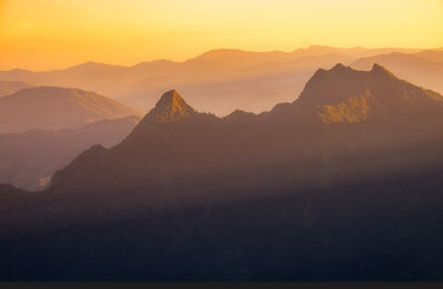 Scenic view of silhouette mountains against sky during sunset