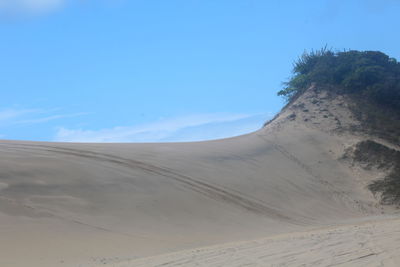 Scenic view of desert against clear blue sky