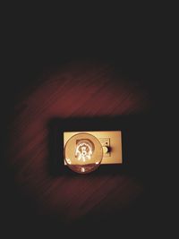Close-up of illuminated lamp on table at home
