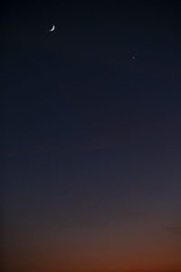 Low angle view of moon in sky at night