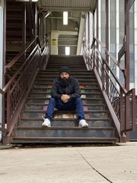 Rear view of man walking on steps