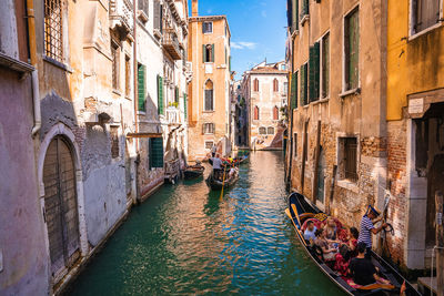Traditional gondolas on the narrow canal in venice, italy.