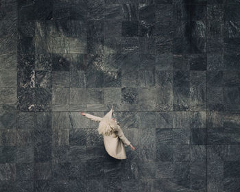 Directly above shot of woman dancing on tiled floor