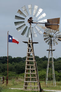 Traditional windmill on field against sky