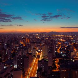 Illuminated cityscape against sky