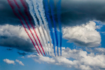 Low angle view of airplane flying against blue sky