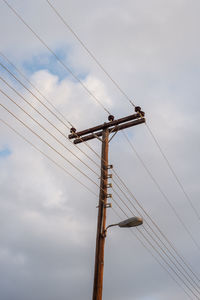 Electric lines on a wooden pole. side view.