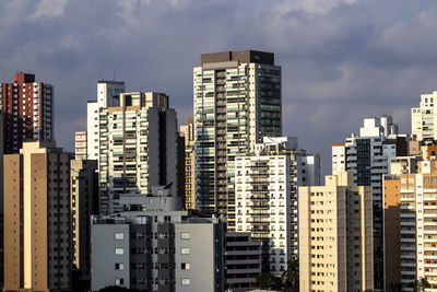 Modern buildings in city against sky