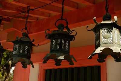 Low angle view of illuminated lanterns hanging on ceiling