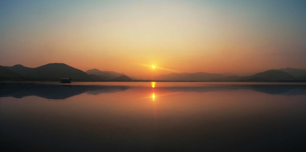 Scenic view of lake against sky during sunset