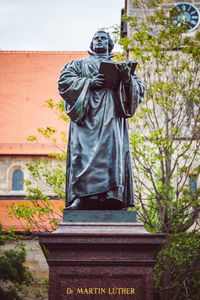 Low angle view of statue against built structure