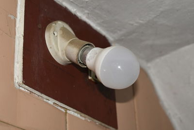 High angle view of electric lamp on wall