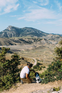 People on landscape against mountain range