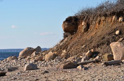 Rocks on beach against sky