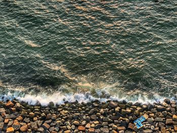 High angle view of rocks at sea shore