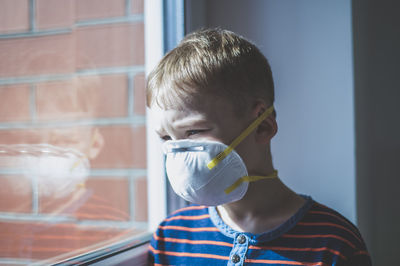 Portrait of boy drinking from window