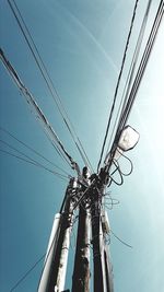 Low angle view of electricity pylon against sky