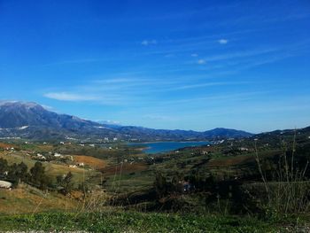 Scenic view of landscape against blue sky