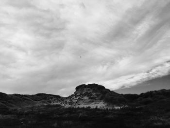 Scenic view of mountains against cloudy sky
