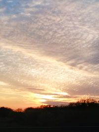 Scenic view of dramatic sky over silhouette landscape