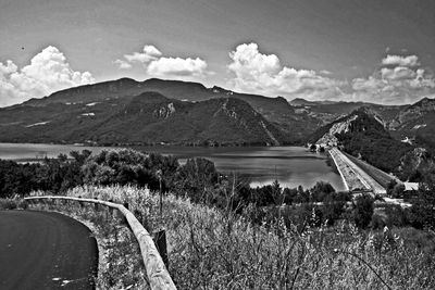 Scenic view of land and mountains against sky