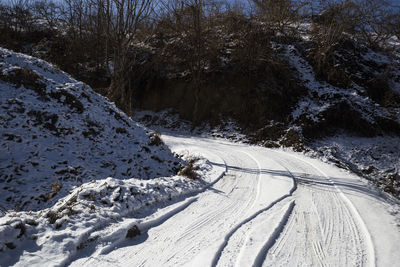 Tire tracks on snow covered road