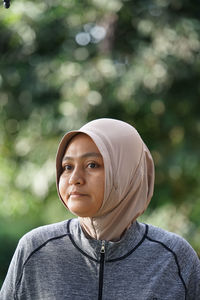 Portrait of young woman standing outdoors