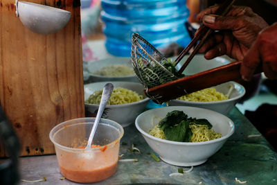 Close-up of person preparing food on table