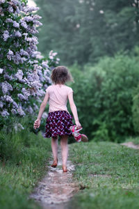 Rear view of woman standing on field