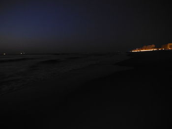 Scenic view of sea against clear sky at night