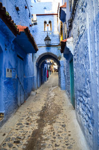 Empty alley amidst buildings in city